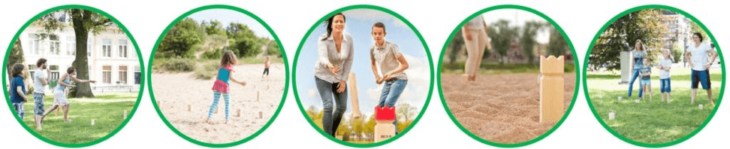 People throwing Kubb sticks on grass with a lot of fun